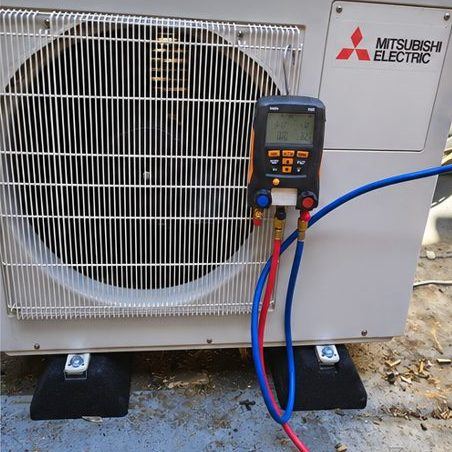 Engineer testing a commercial air-conditioning unit