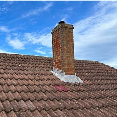 Tiled roof with chimney flashing renewed